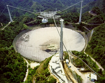 The 305m diameter radio dish of the Arecibo Observatory in Puerto Rico. Photo credit: NAIC